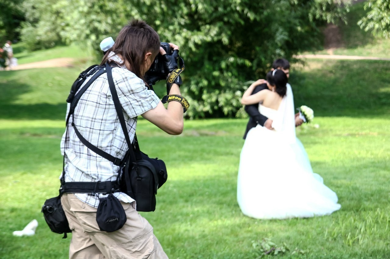 Фотограф. Свадебный фотограф. Фотограф на свадьбу. Профессиональный фотограф на свадьбе. Фотограф фотографирует свадьбу.